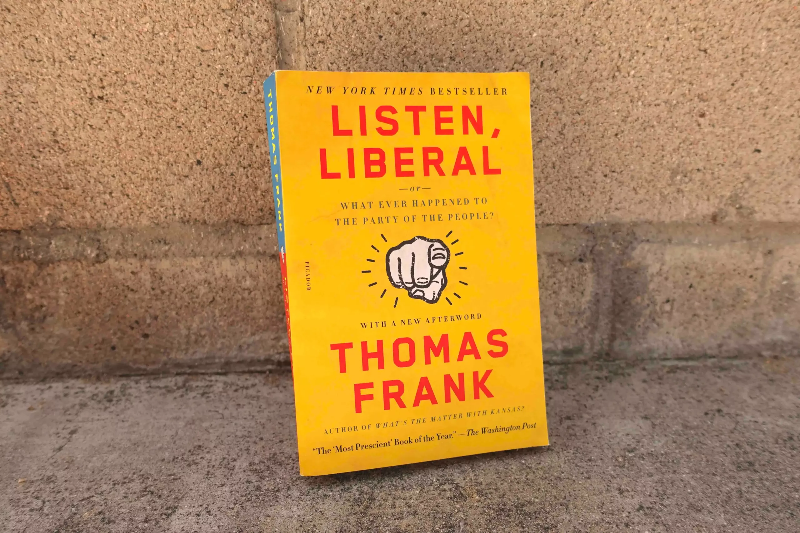 listen liberal paperback book against a wall