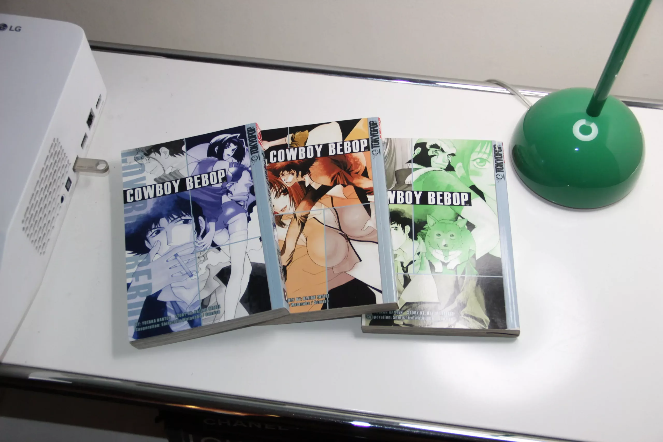three cowboy bebop paperback manga volumes on desk