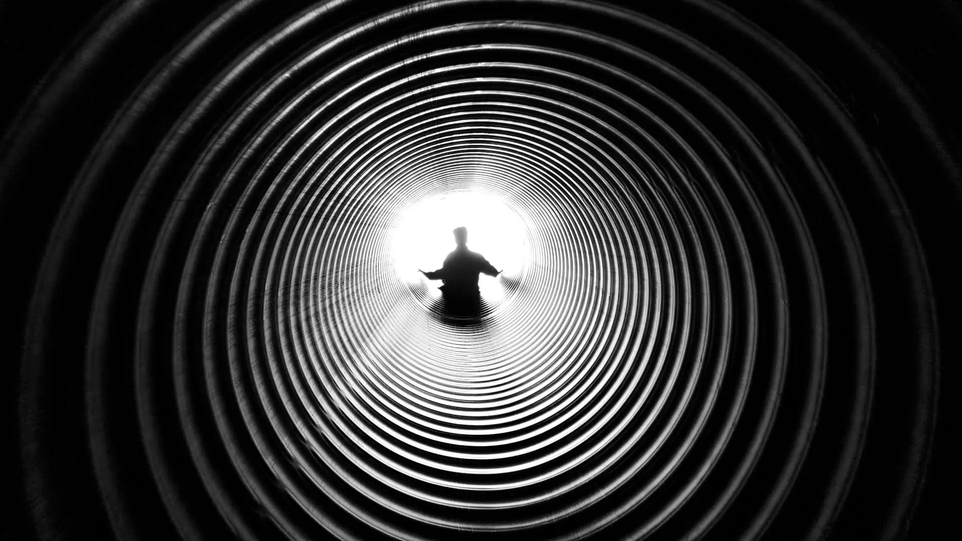 person looking down a dark well