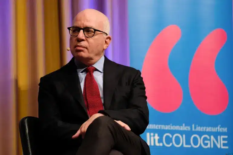 Michael Wolff Sitting With His Hands and Legs Crossed