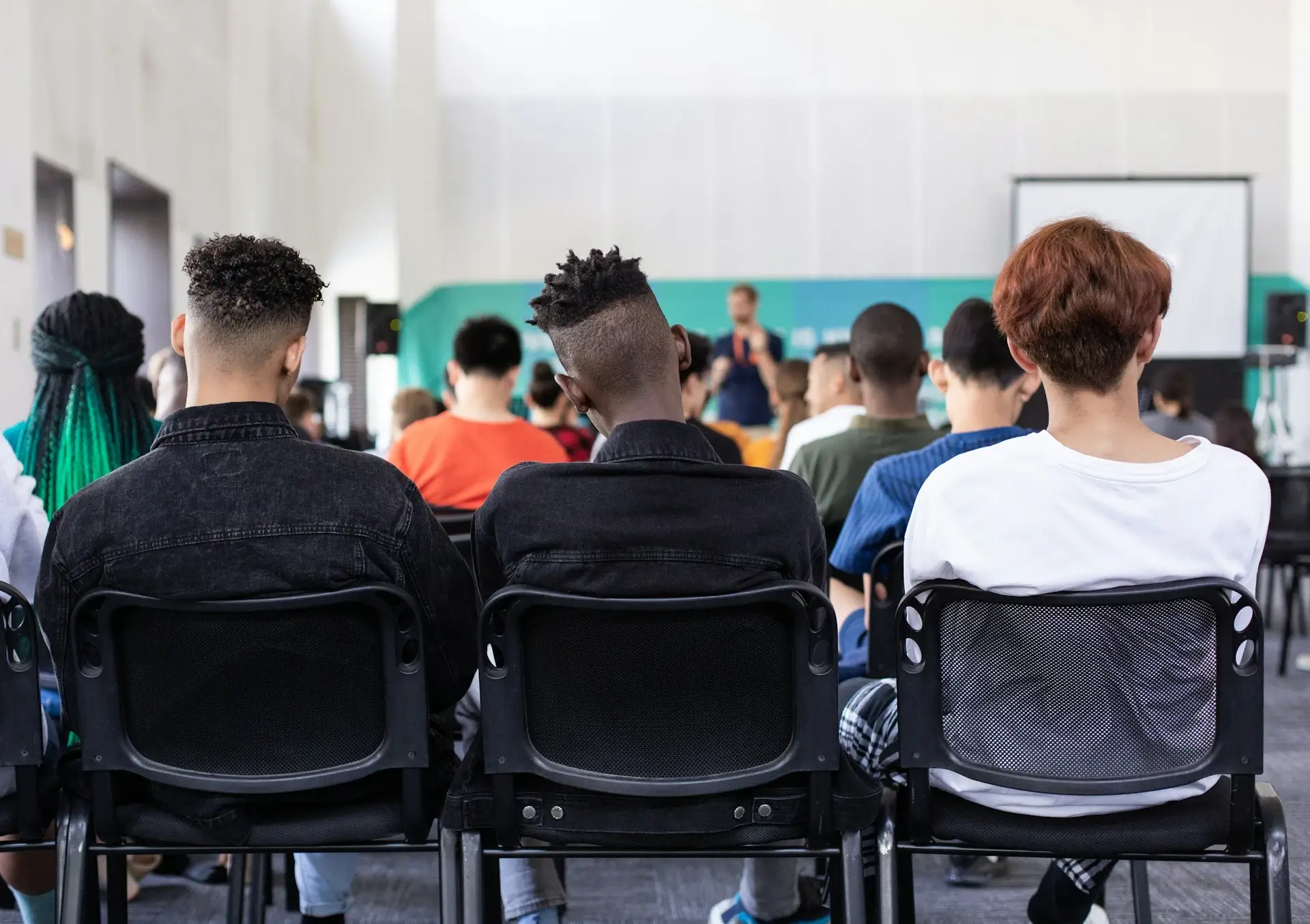 Three Teenage Boy Students in the Back of a Classroom