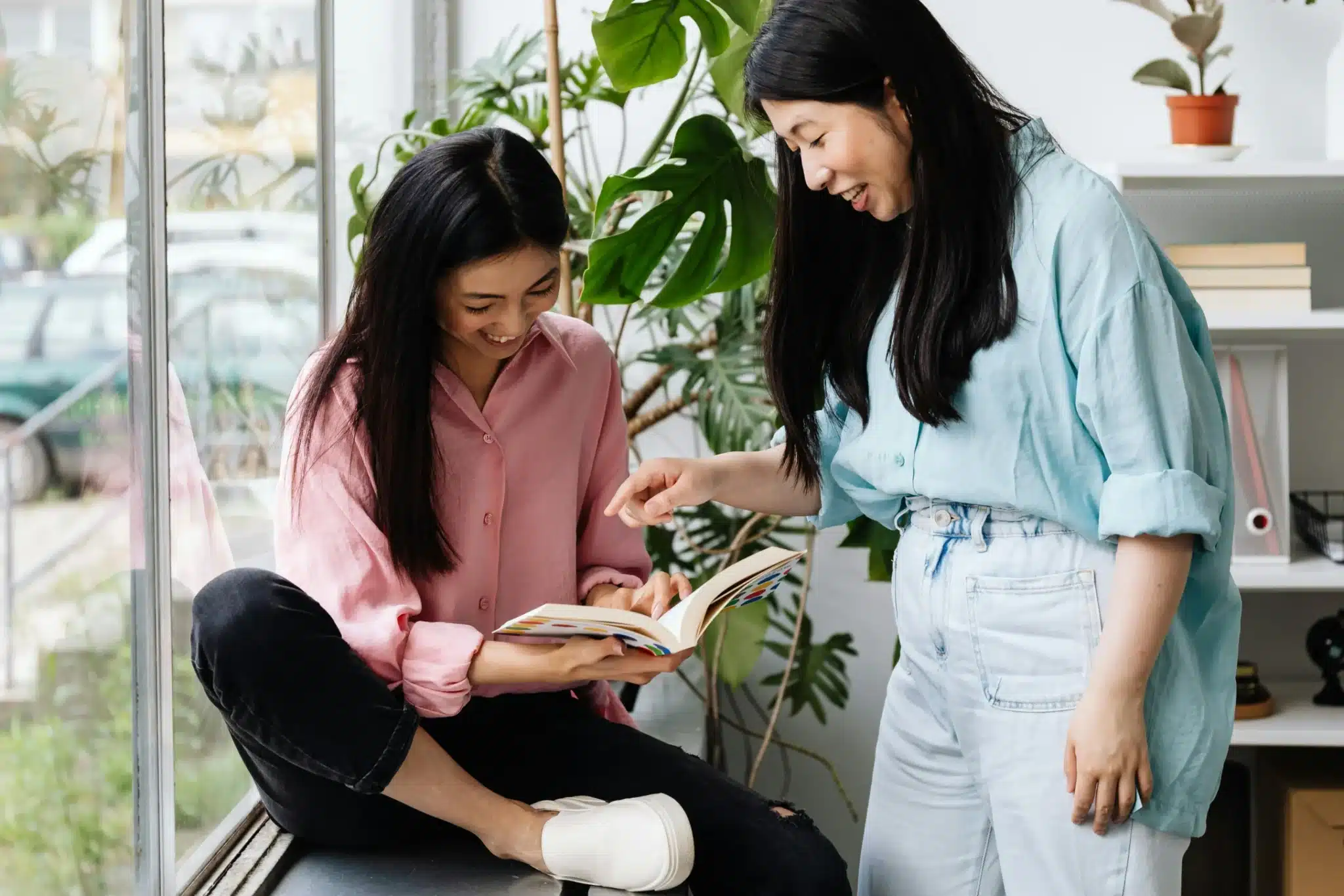 Two Women Reading a Book Together