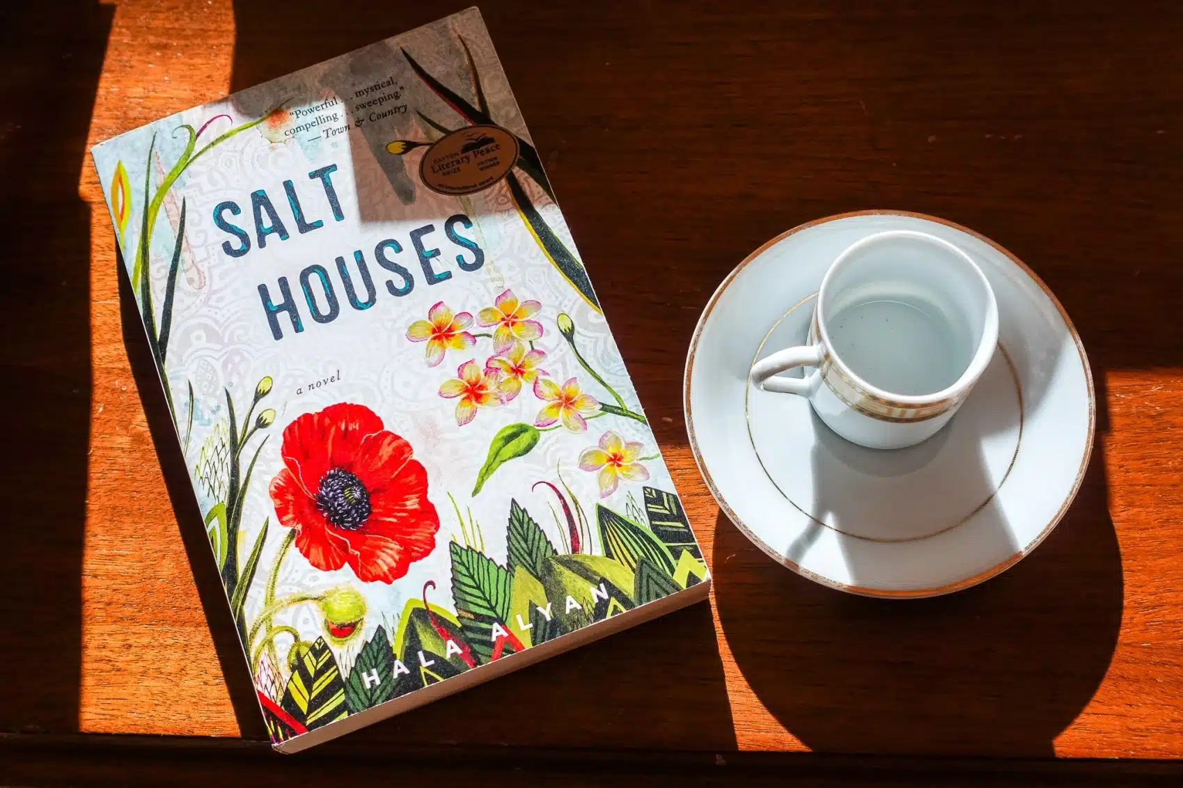 Salt Houses, a Paperback Novel by Hala Alyan, and a Coffee Cup and Saucer