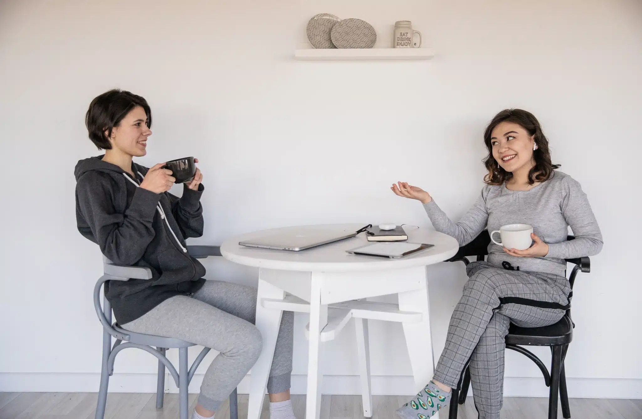 Two Women Discussing Work Over Coffee