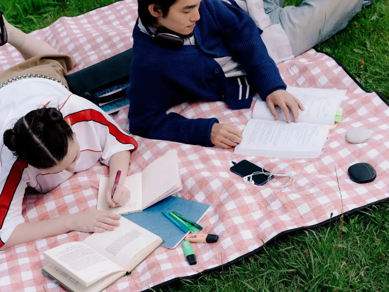 Two People Reading Books on a Picnic Blanket Two People Reading Books on a Picnic Blanket
